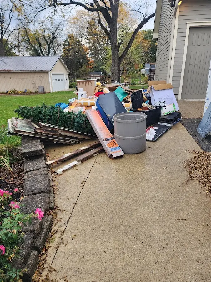 Dumpster being loaded with debris for Residential Dumpster Rental in Ida